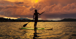 is your core in super shape - image of woman paddleboarding